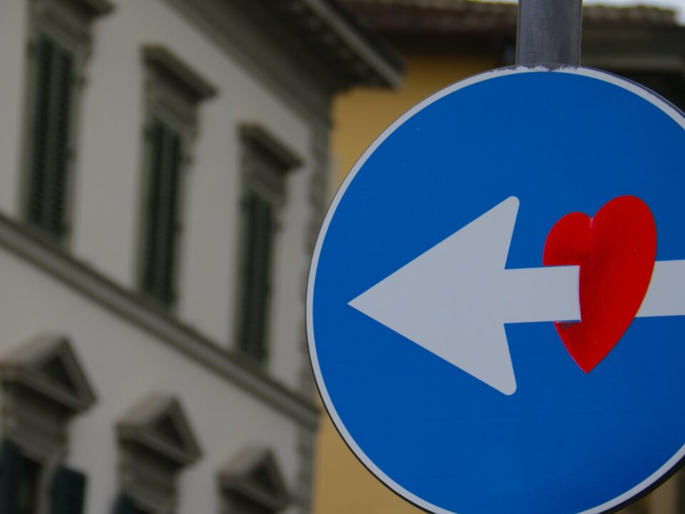 white arrow through red heart road signage