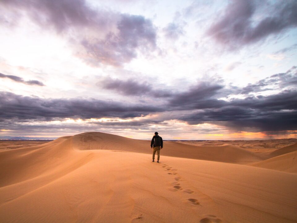 man walking on desert