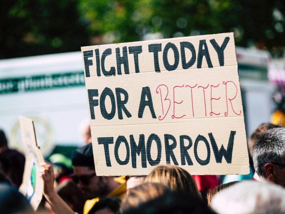 person holding fight today for a better tomorrow sign