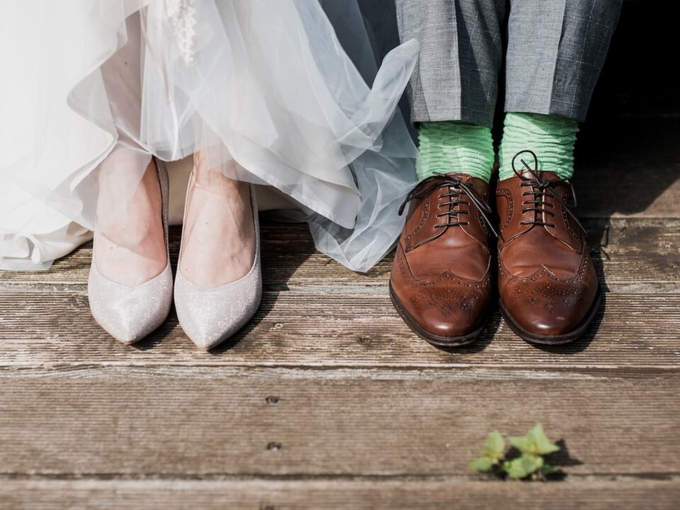 two people standing on brown wooden floor