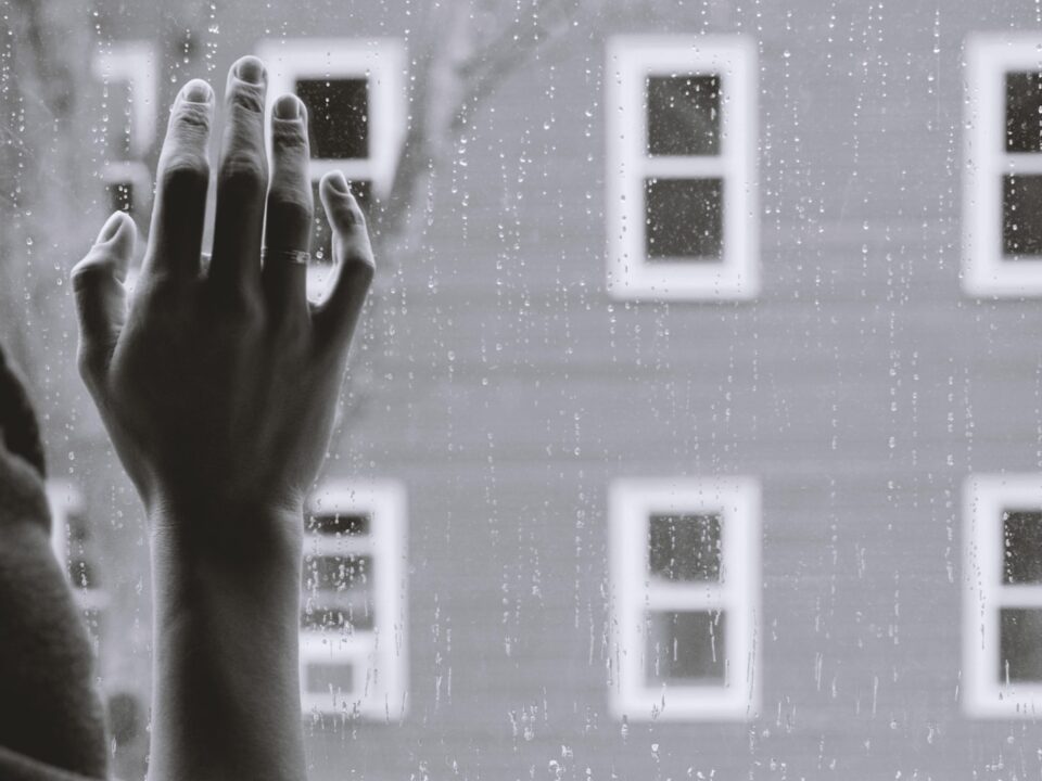 grayscale photo of woman right hand on glass