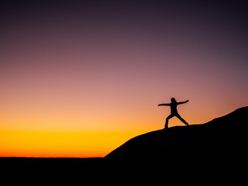 shillouette photo of person standing at the peak