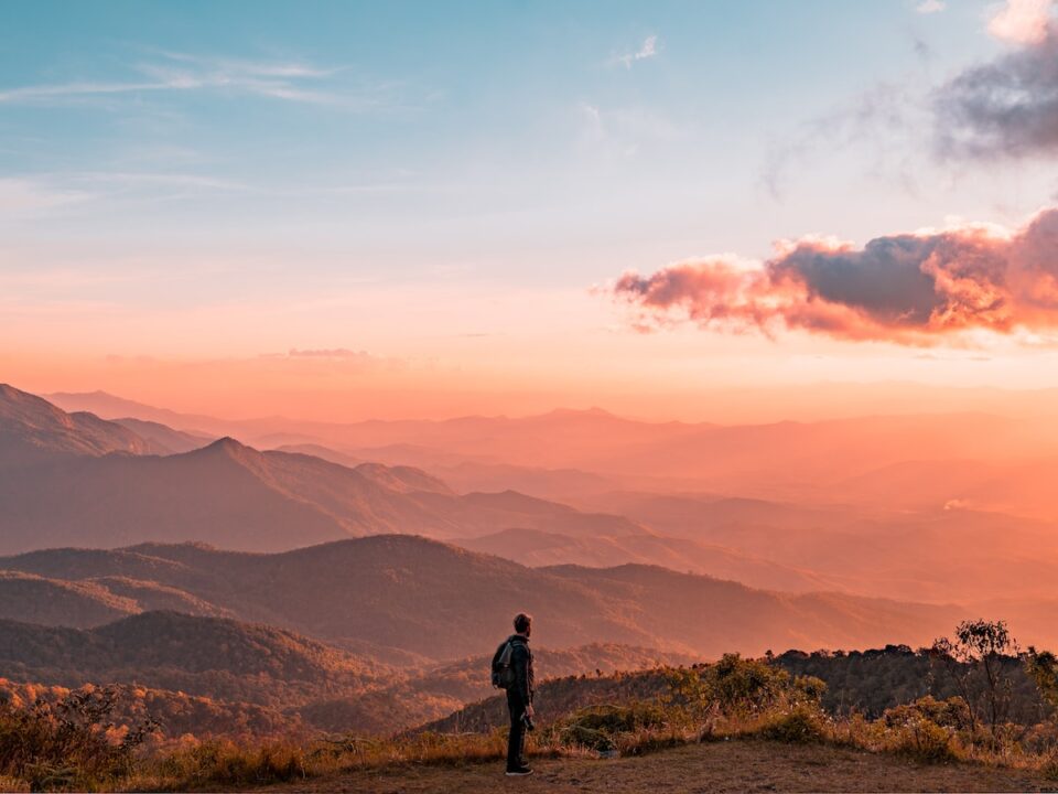man standing on hill digital wallpaper
