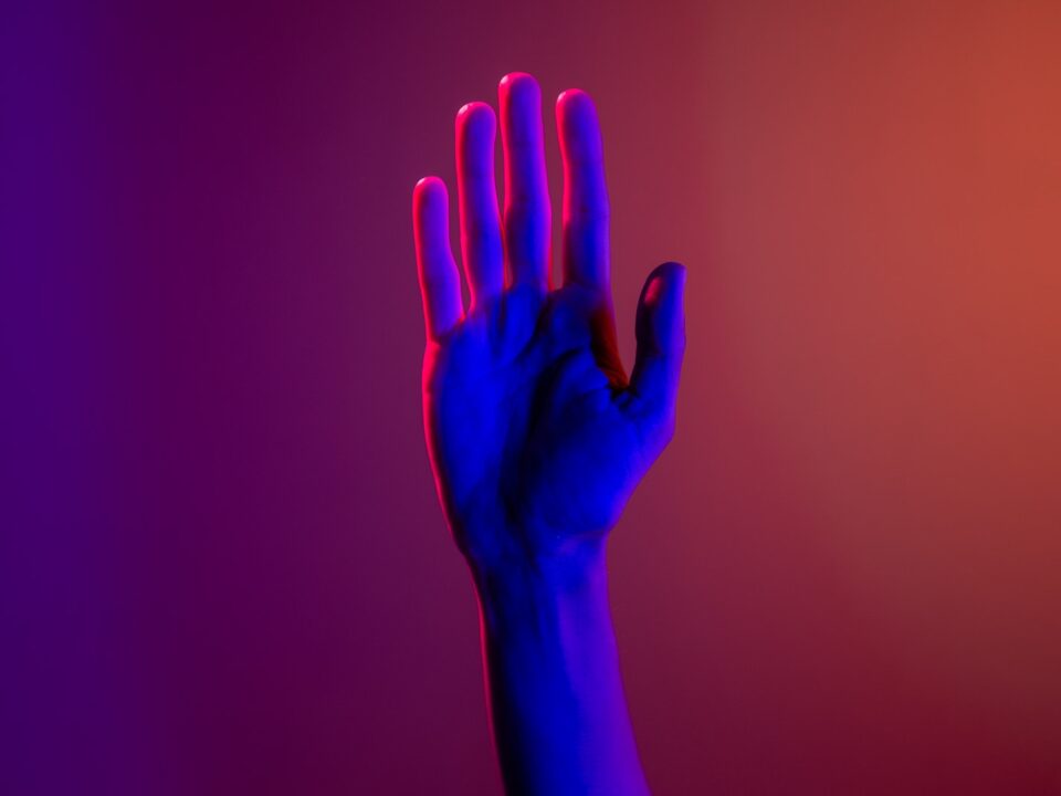 Persons Left Hand With Purple Manicure