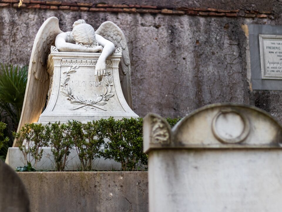 photography of lying angel statue
