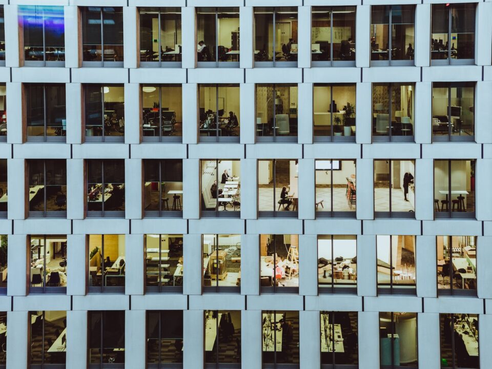 people inside high-rise building with concrete wall