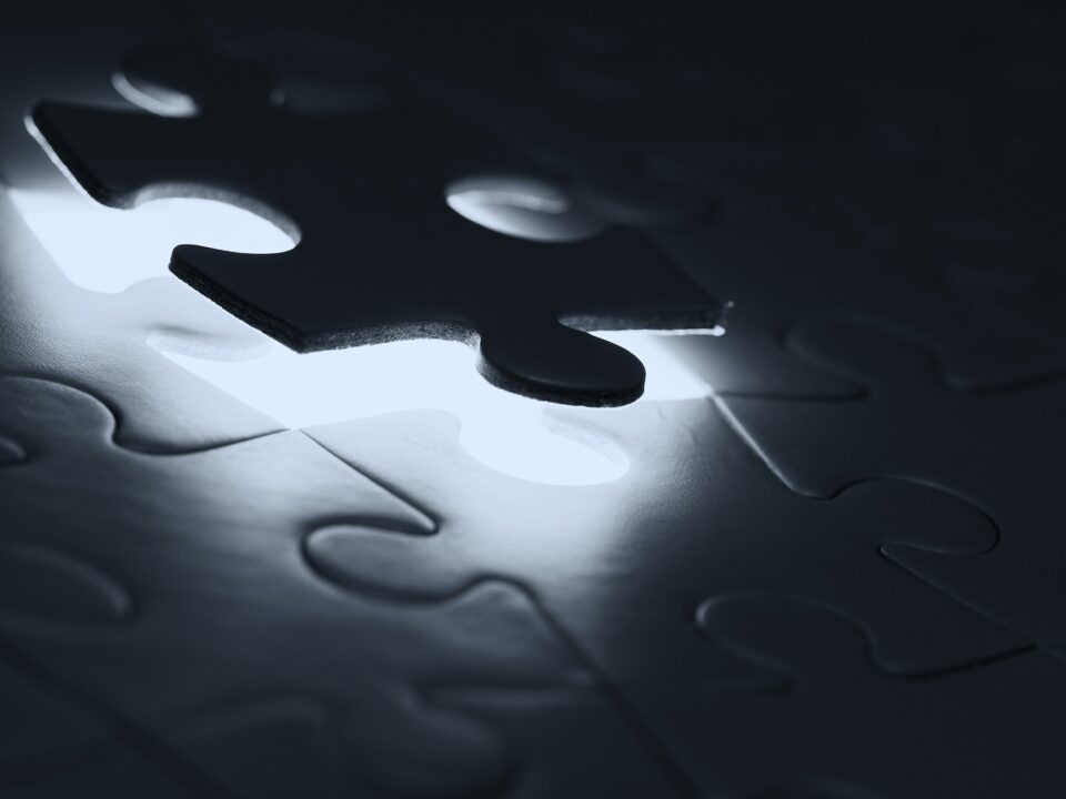 black puzzle piece on white paper