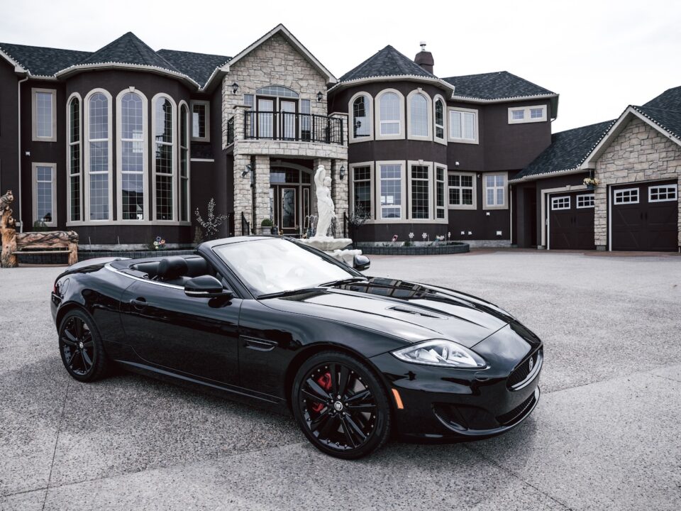 black convertible coupe parked near house
