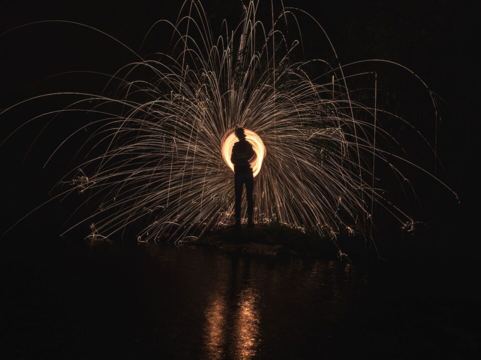 time lapse photography of person standing in front of lights