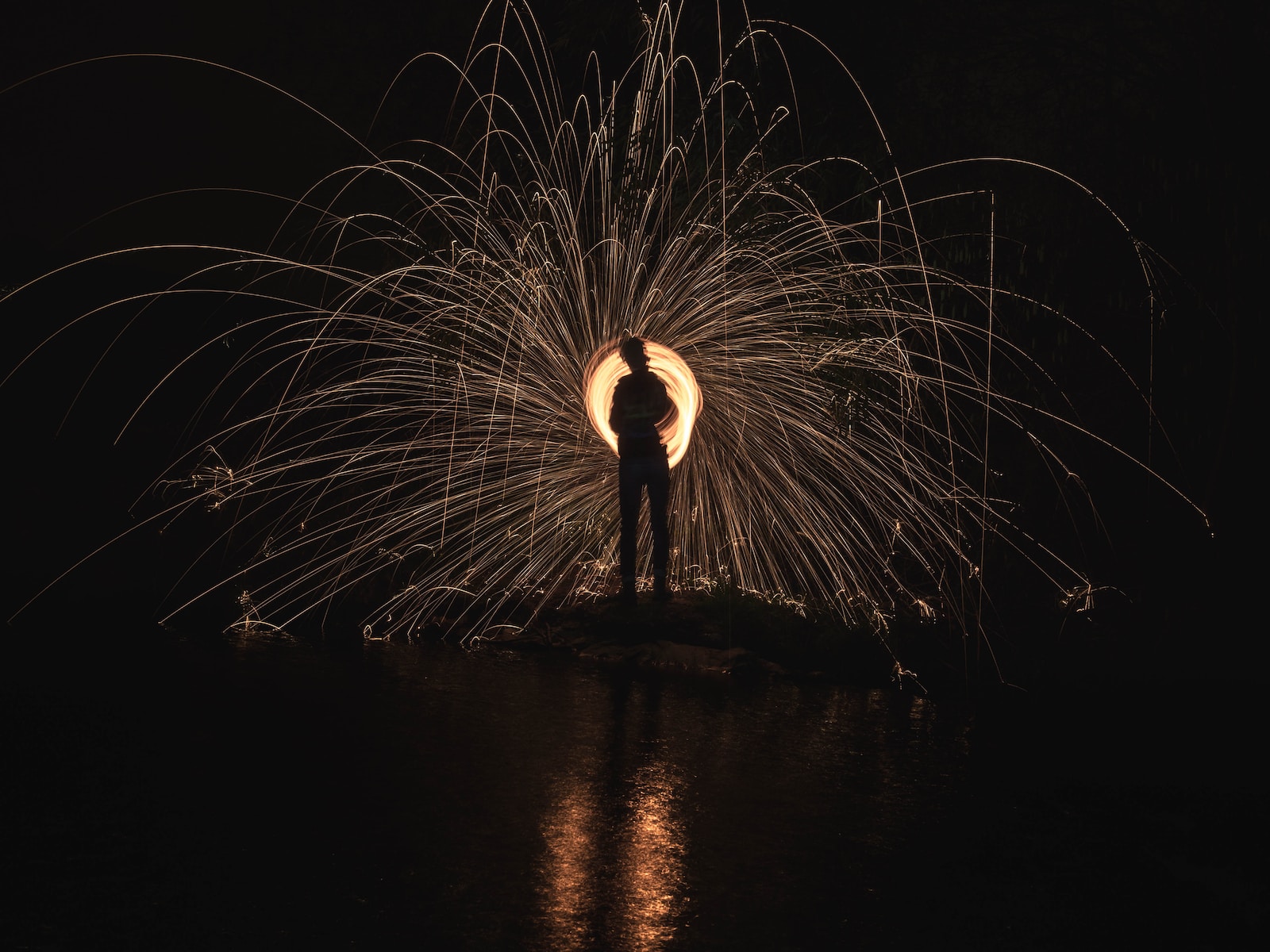 time lapse photography of person standing in front of lights