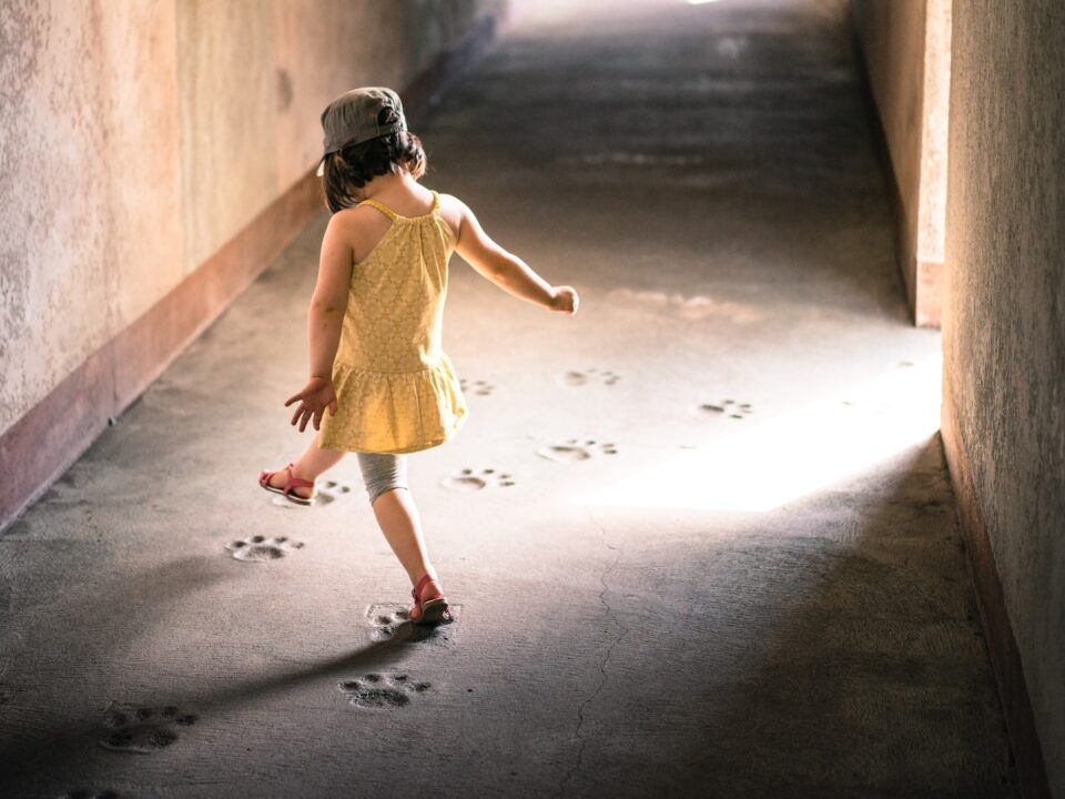 girl stepping on paw prints