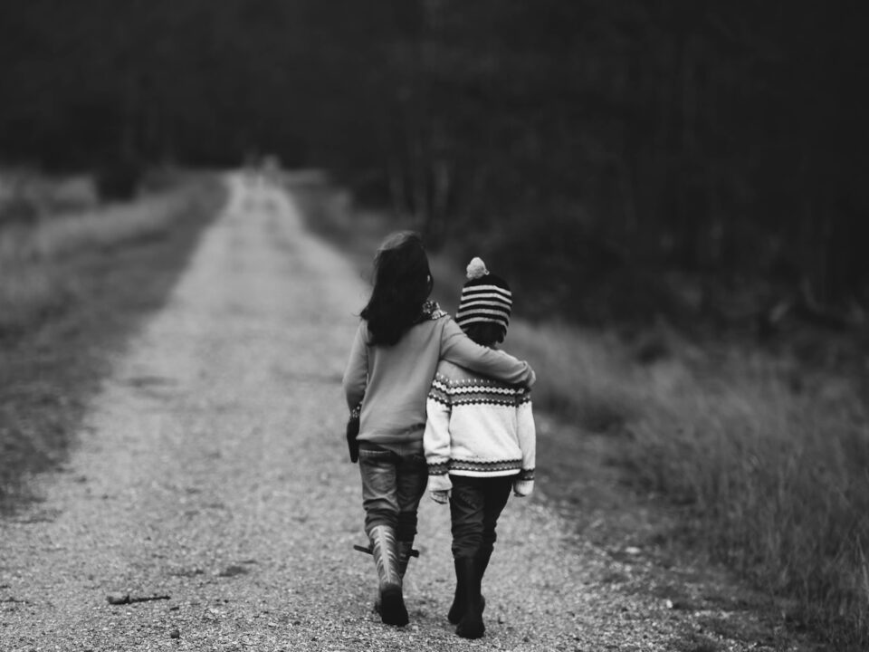 grayscale photography of kids walking on road