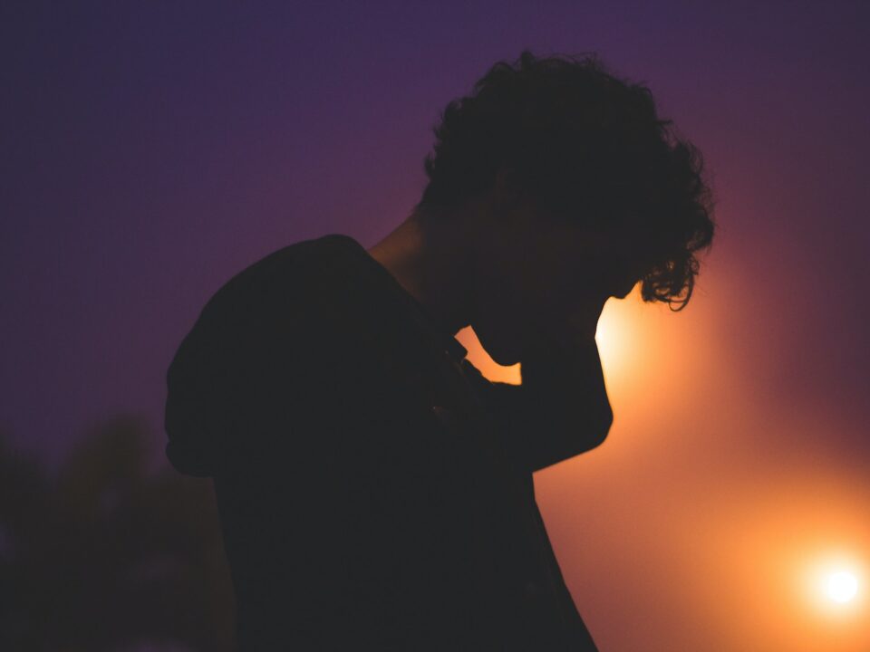 silhouette of man with light on his face