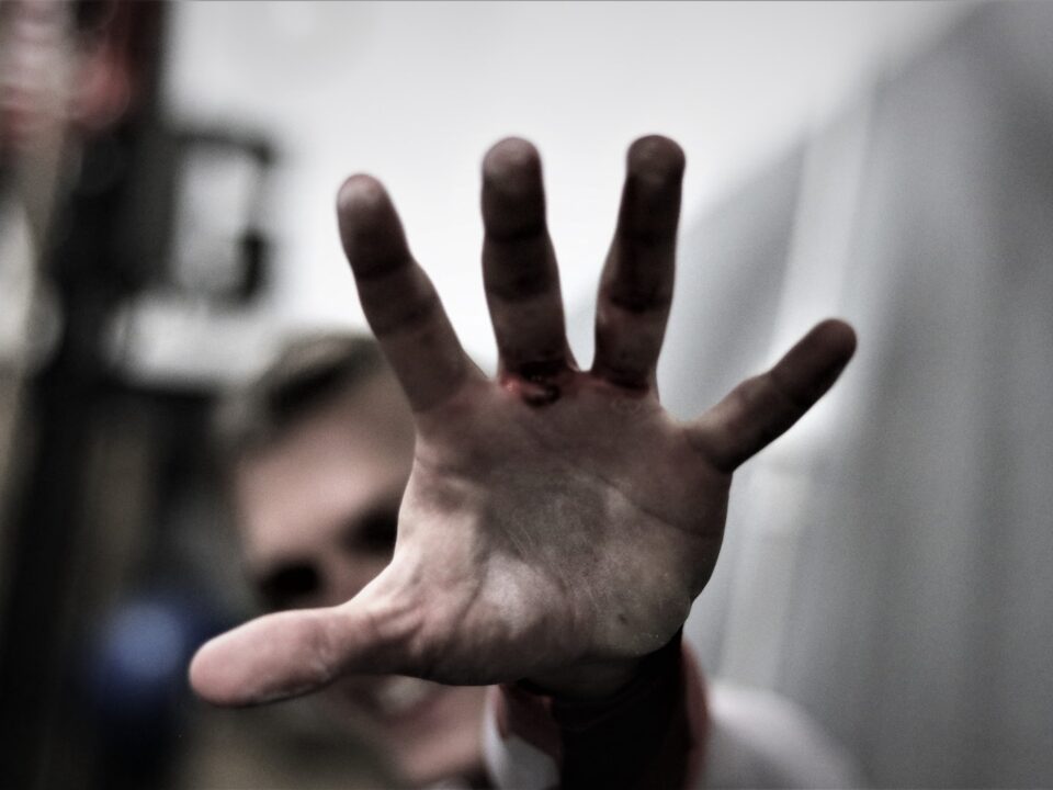 persons left hand in tilt shift lens
