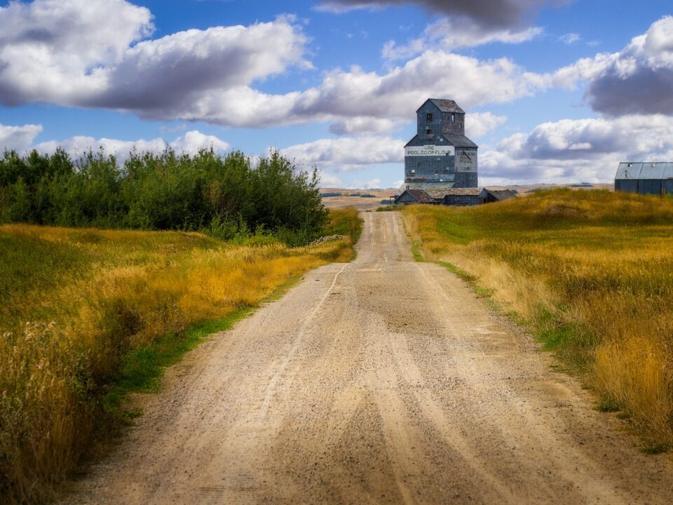a train traveling down a dirt road