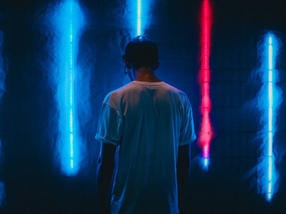 man standing near blue LED strips