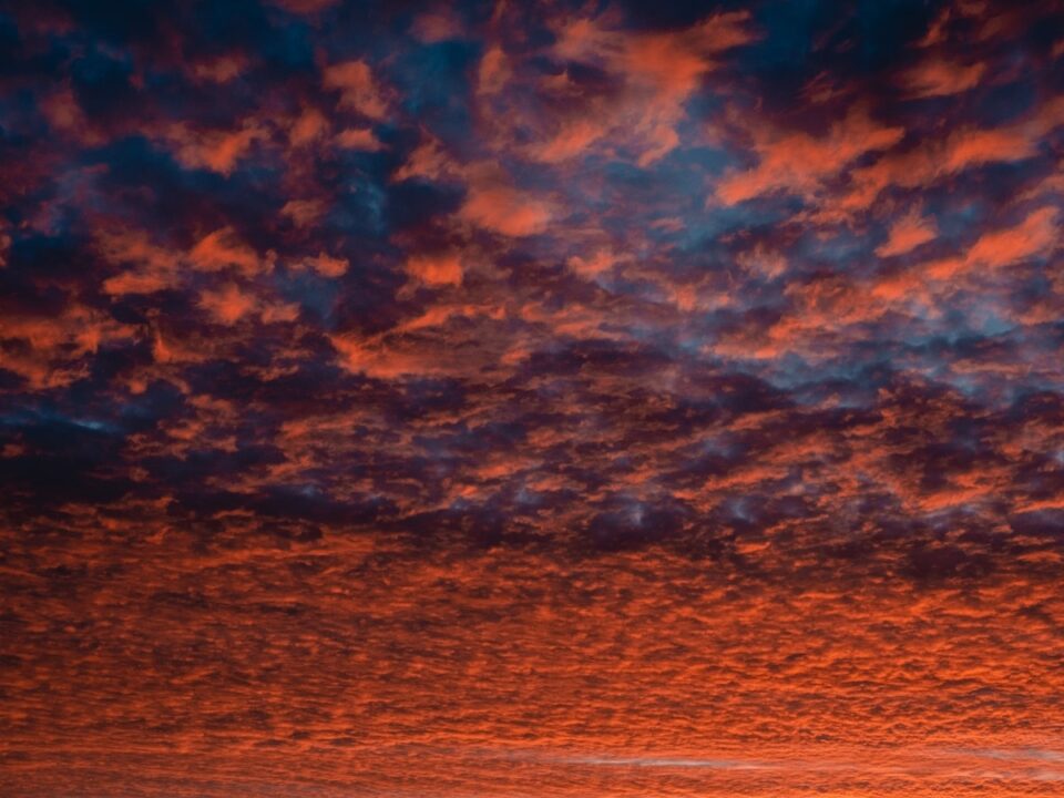 a red sky with a few clouds in it