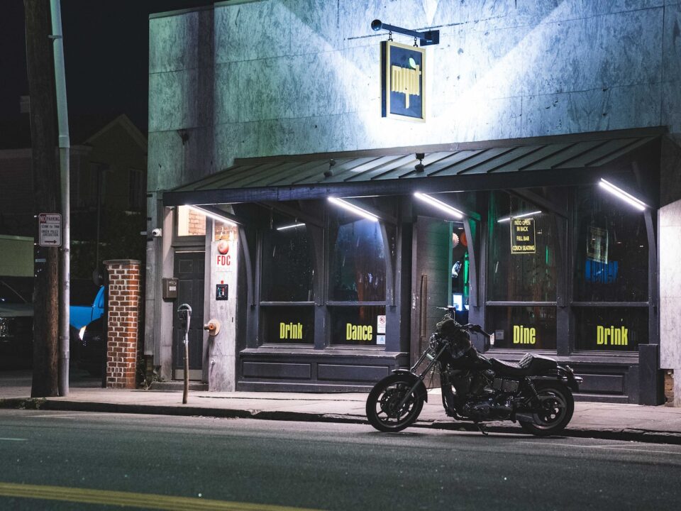 a motorcycle parked in front of a building at night