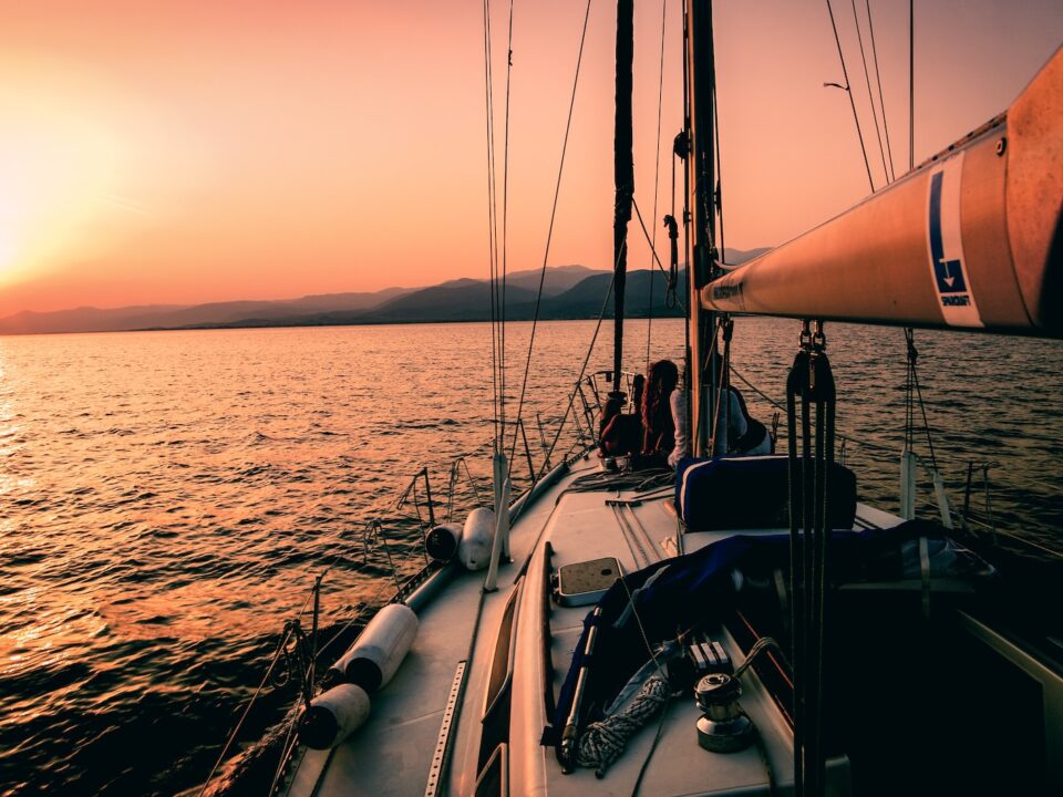 white and black sailboat during sunset