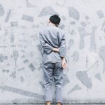 man standing in front of wall