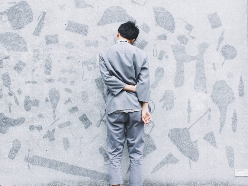 man standing in front of wall