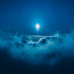 full moon along clouds