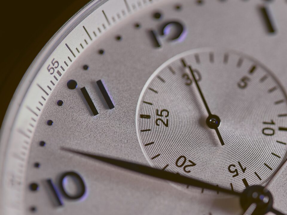 a close up of a silver watch face