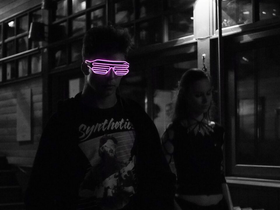 selected color of pink sunglasses wearing man in black jacket