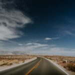 an empty road in the middle of a desert