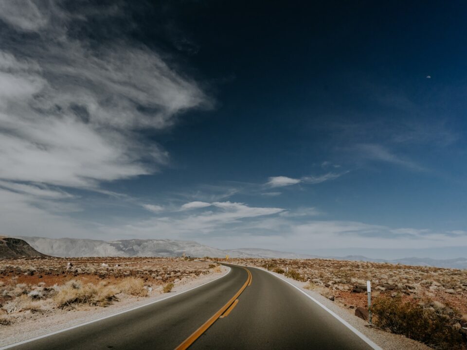 an empty road in the middle of a desert