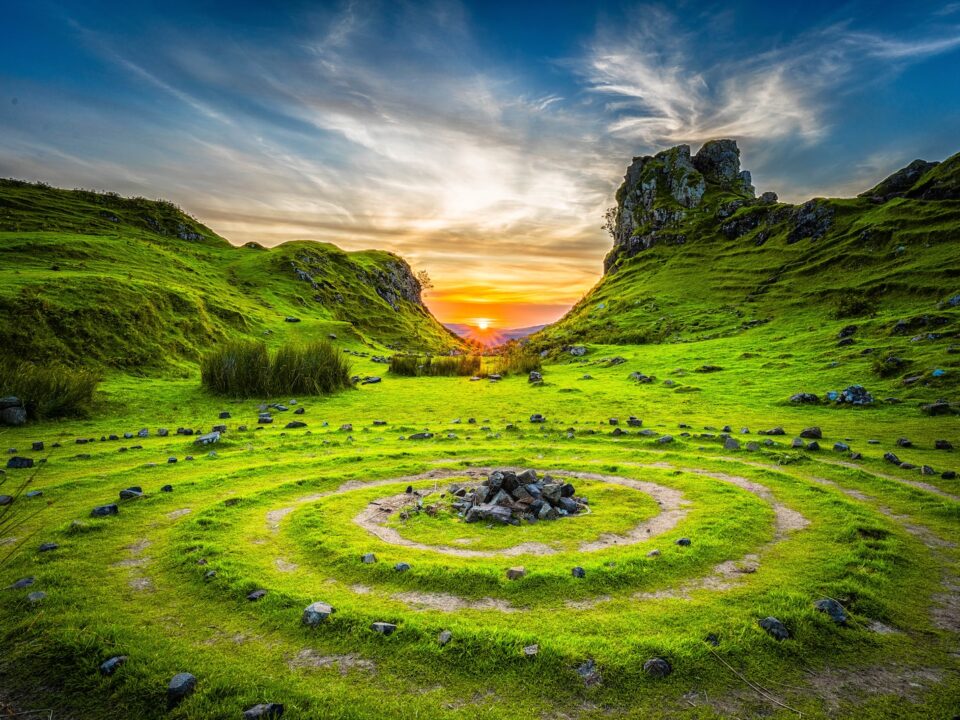 green grass field during sunset