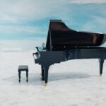 a black piano sitting on top of a white floor