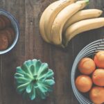ripe banana fruit beside stainless steel fruit rack