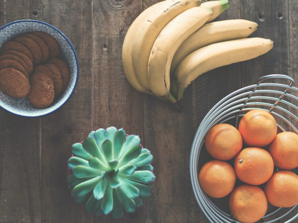 ripe banana fruit beside stainless steel fruit rack
