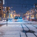 two trams with lights on