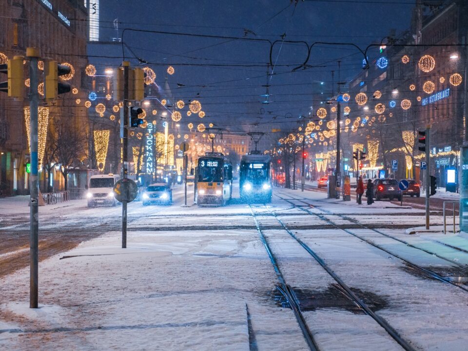 two trams with lights on