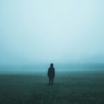 person standing on misty ground
