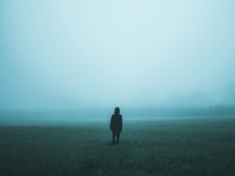 person standing on misty ground
