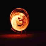 timelapse photography of person fire dancing