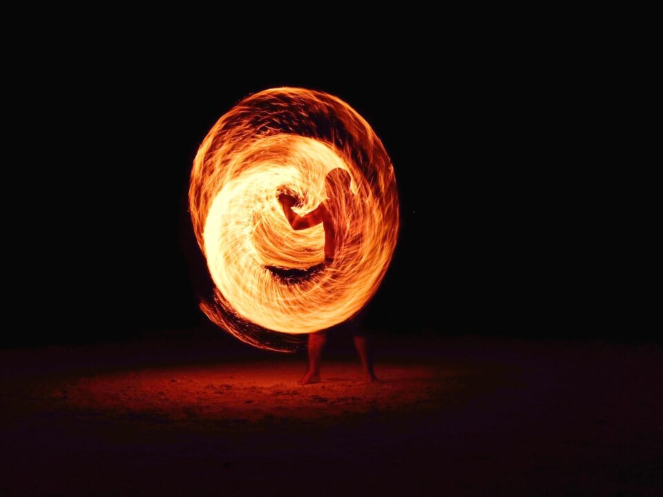 timelapse photography of person fire dancing