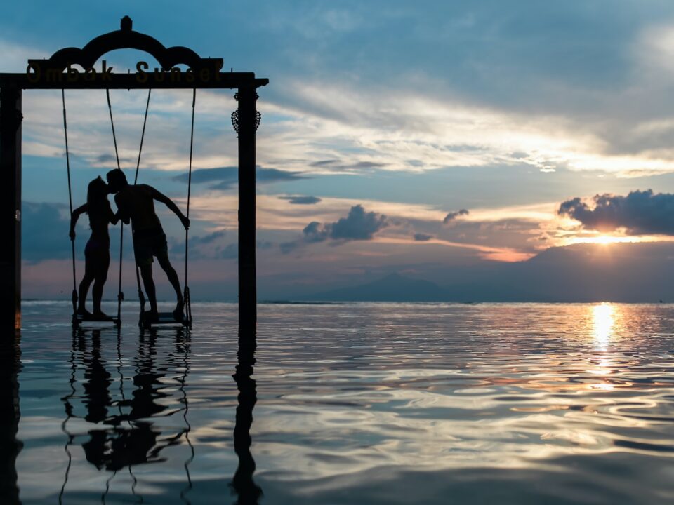 a couple standing in the sea while kissing