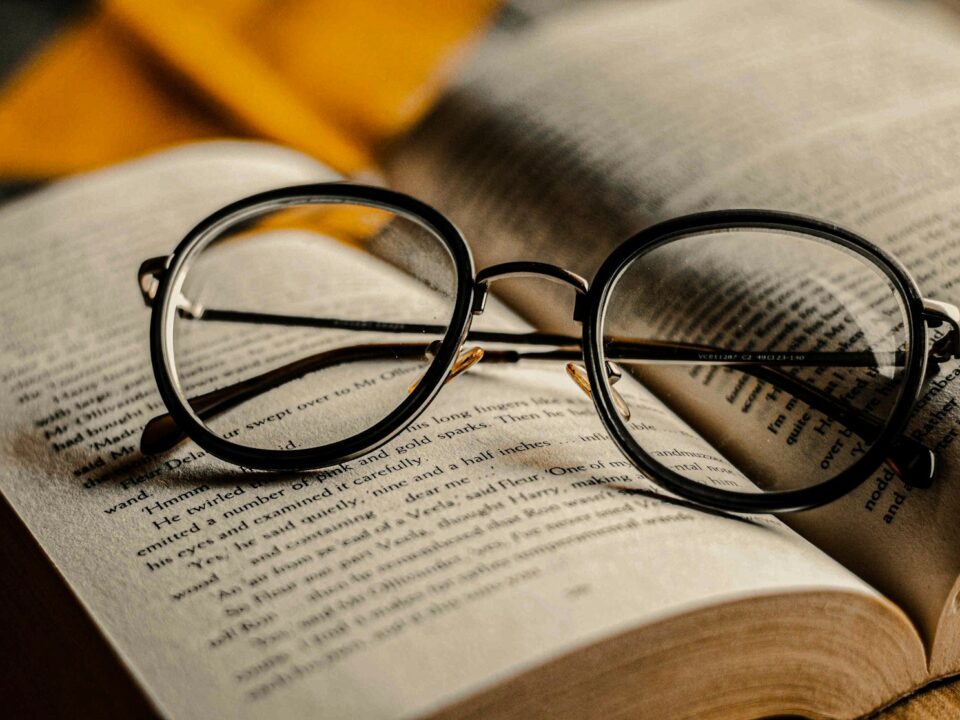 black framed eyeglasses on book page