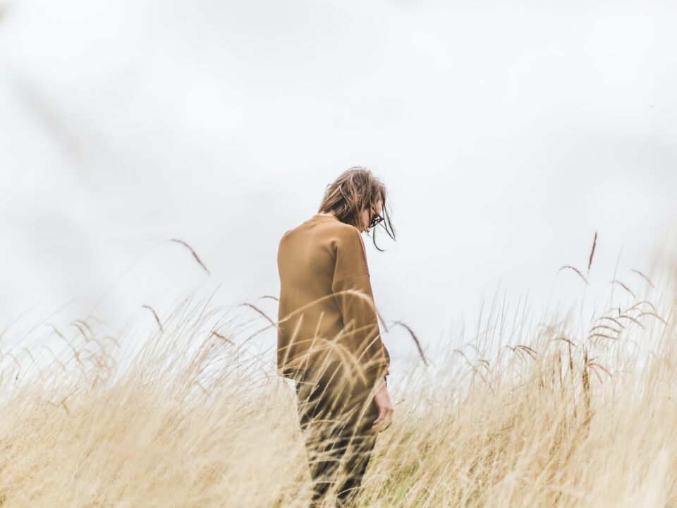 person standing in the middle of wheat field
