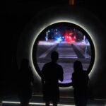 a couple of people that are standing in the dark