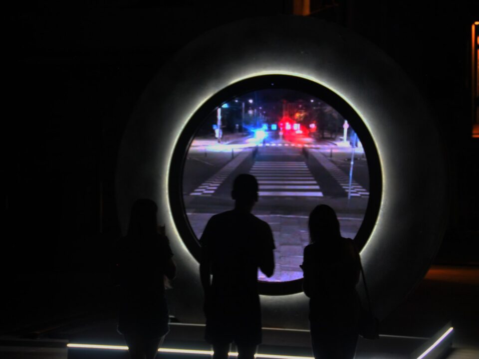 a couple of people that are standing in the dark