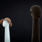 a white and a brown object on a black background