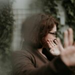 man in brown sweater wearing black framed eyeglasses