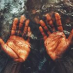 persons hand on water