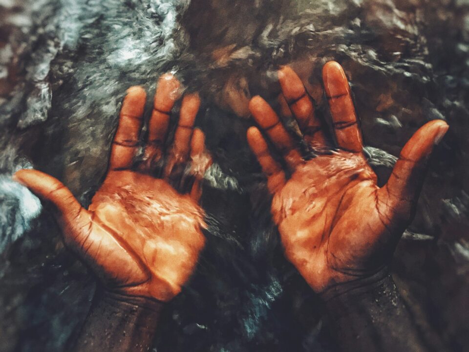 persons hand on water