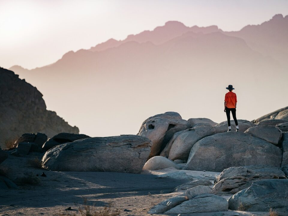 a person standing on top of a large rock